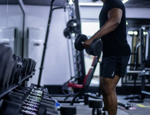 A man taking dumbbells